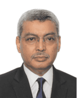 Modern professional portrait of a businessman in formal attire on a grey background.