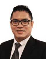 Portrait of a professional man in formal attire with glasses.